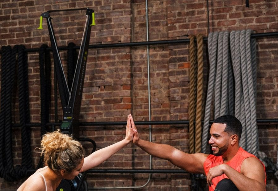 Two athletes high-fiving after a training session